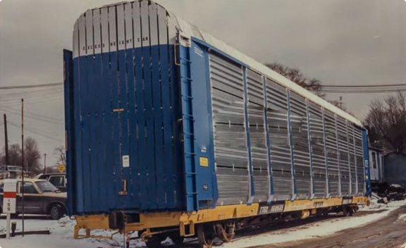 A tall blue autorack with Tri-Level Hinge Decks