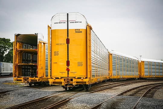 A yellow tri-level autorack