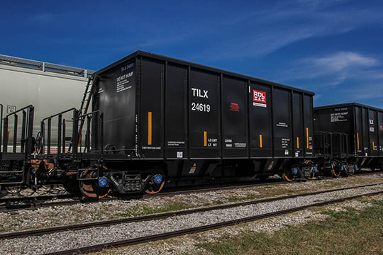 A longitudinal hopper car